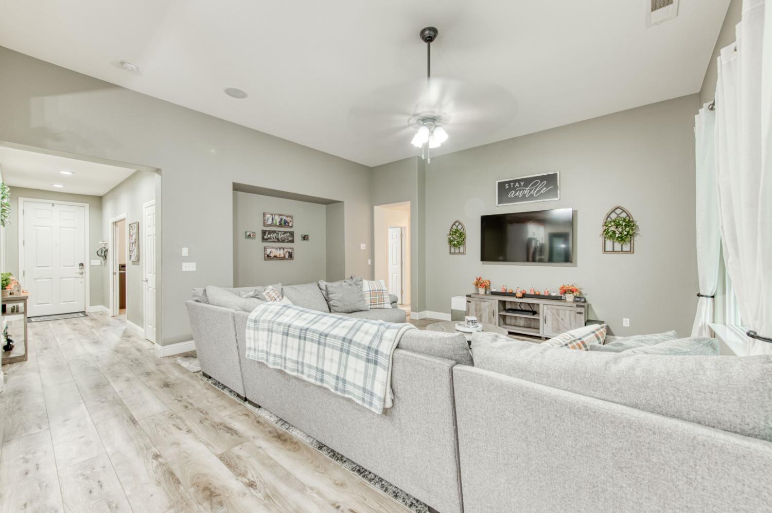 3334 Bellaire Avenue Clovis, CA 93619 - Photo 25 of 54 a living room with furniture and a flat screen tv