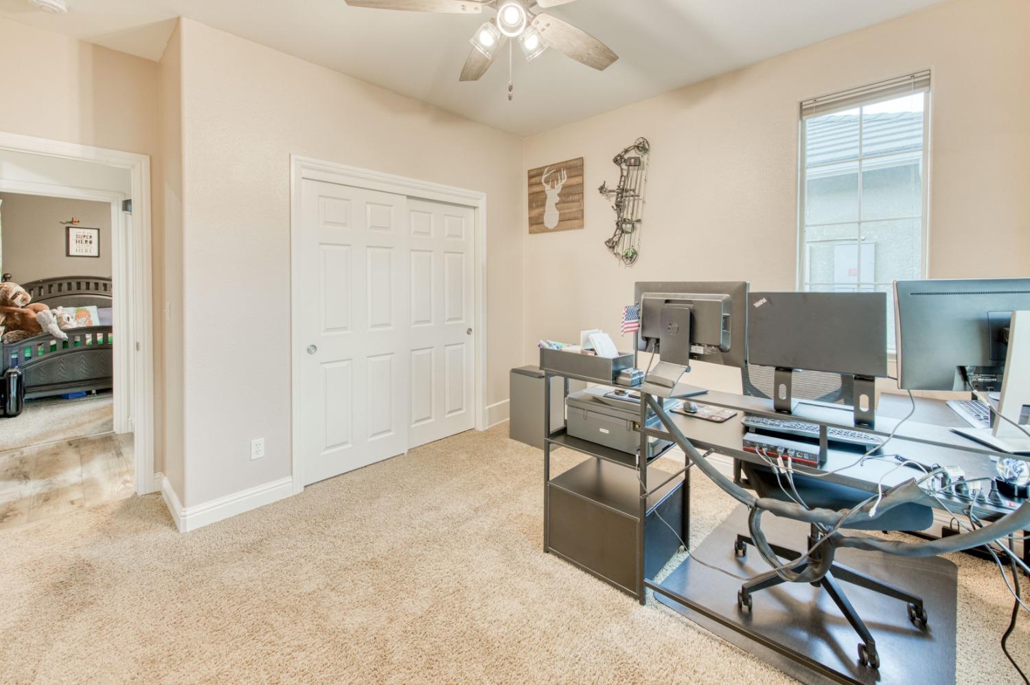 3334 Bellaire Avenue Clovis, CA 93619 - Photo 28 of 54 a workspace with furniture and chandelier fan