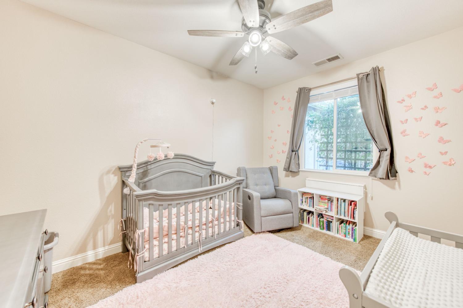 3334 Bellaire Avenue Clovis, CA 93619 - Photo 30 of 54 a living room with furniture a fireplace and a chandelier