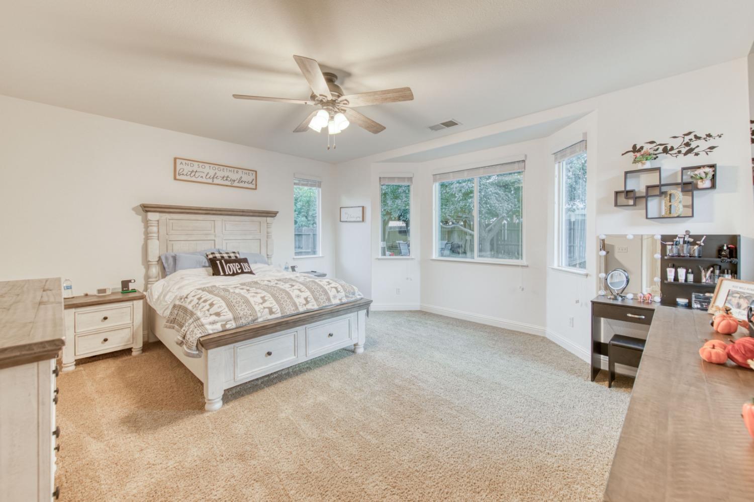 3334 Bellaire Avenue Clovis, CA 93619 - Photo 36 of 54 a bedroom with a large bed and a chandelier