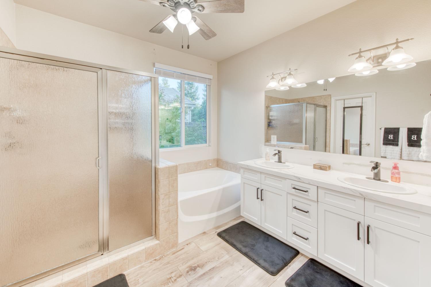 3334 Bellaire Avenue Clovis, CA 93619 - Photo 37 of 54 a spacious bathroom with a double vanity sink mirror and shower
