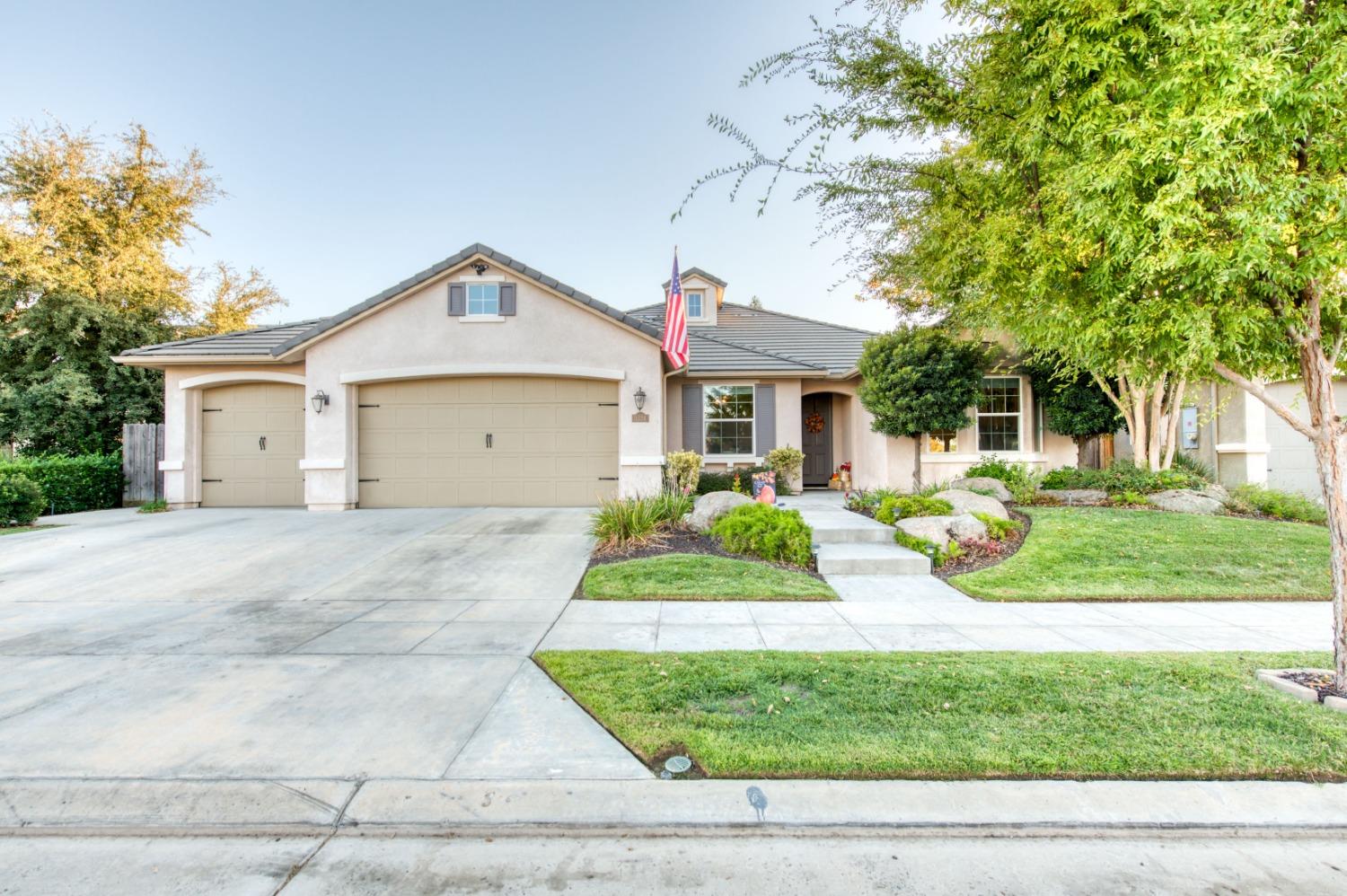 3334 Bellaire Avenue Clovis, CA 93619 - Photo 45 of 54 a front view of a house with a yard and garage