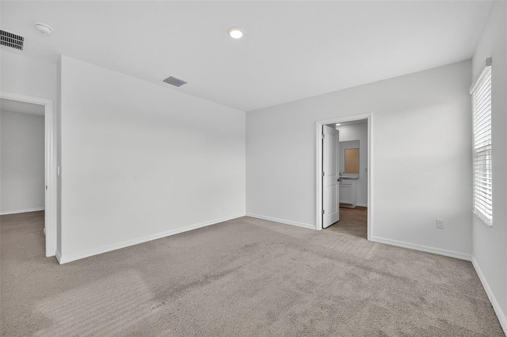 3842 Sunny Spring Street Plant City, FL 33565 - Photo 11 of 46 an empty room with windows and closet