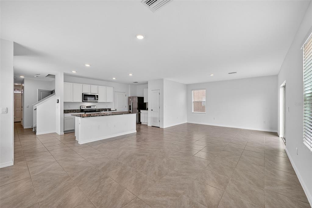 3842 Sunny Spring Street Plant City, FL 33565 - Photo 6 of 46 a view of kitchen with refrigerator and white cabinets