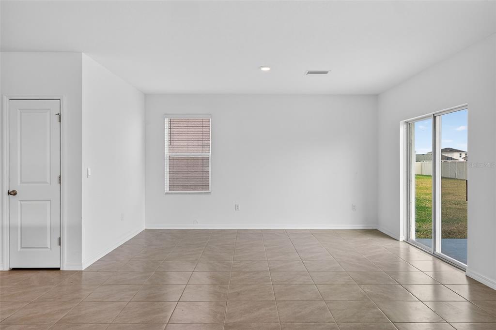 3842 Sunny Spring Street Plant City, FL 33565 - Photo 7 of 46 a view of an empty room with wooden floor and a window