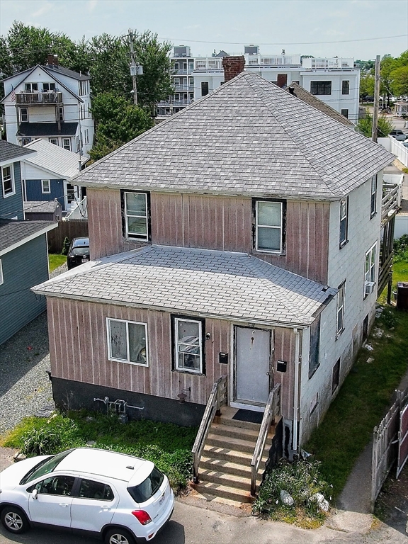 4 Atherton Road Hull, MA 02045 - Photo 2 of 8 a aerial view of a house with a yard table and chairs