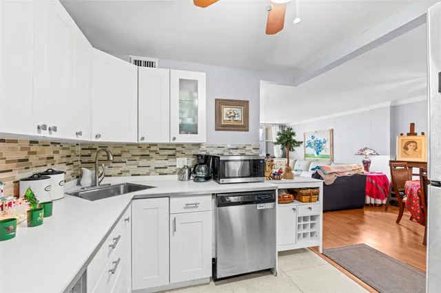 a bathroom with a granite countertop sink a toilet and a mirror
