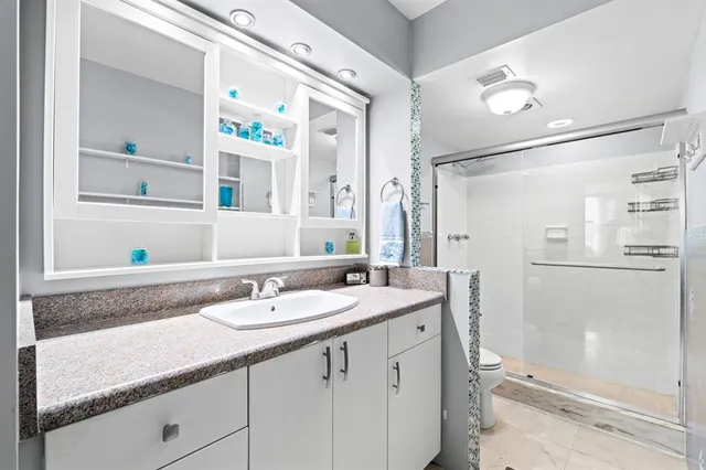 a bedroom with bed and a potted plant