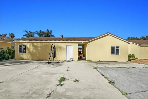 a view of yellow house with a street
