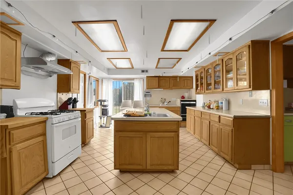 a large kitchen with a table and chairs