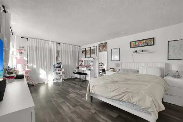 a spacious bedroom with a large bed and a window