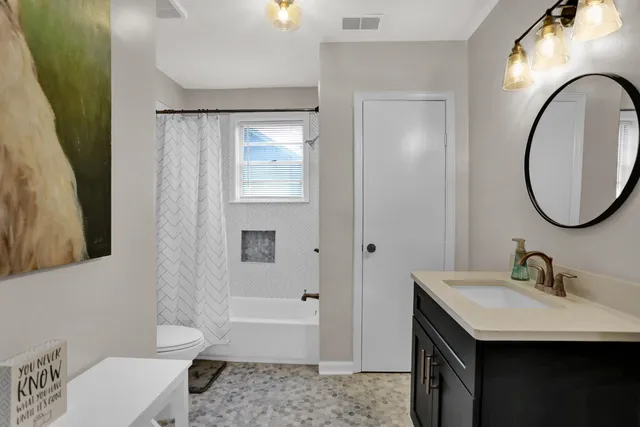 a bathroom with a sink a toilet and a mirror