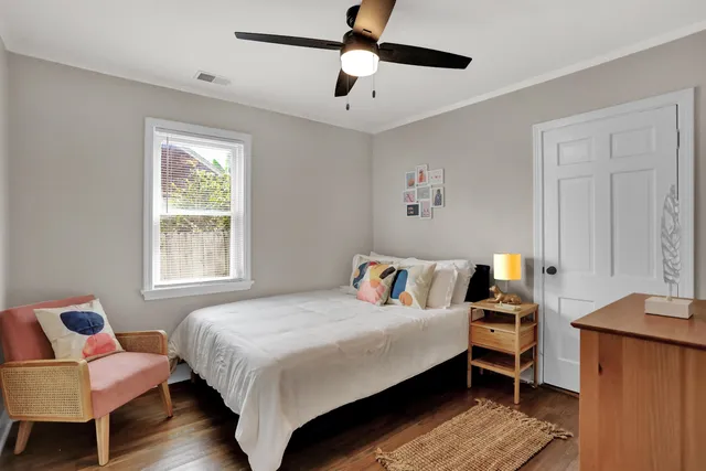 a bedroom with a bed wooden floor and a window