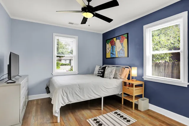 a bedroom with a bed and wooden floor