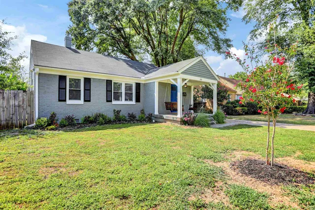 a front view of house with yard and green space