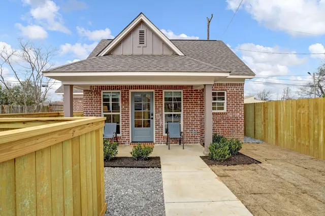 a front view of a house with garden