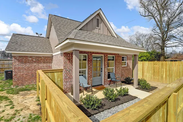 a front view of a house with large windows