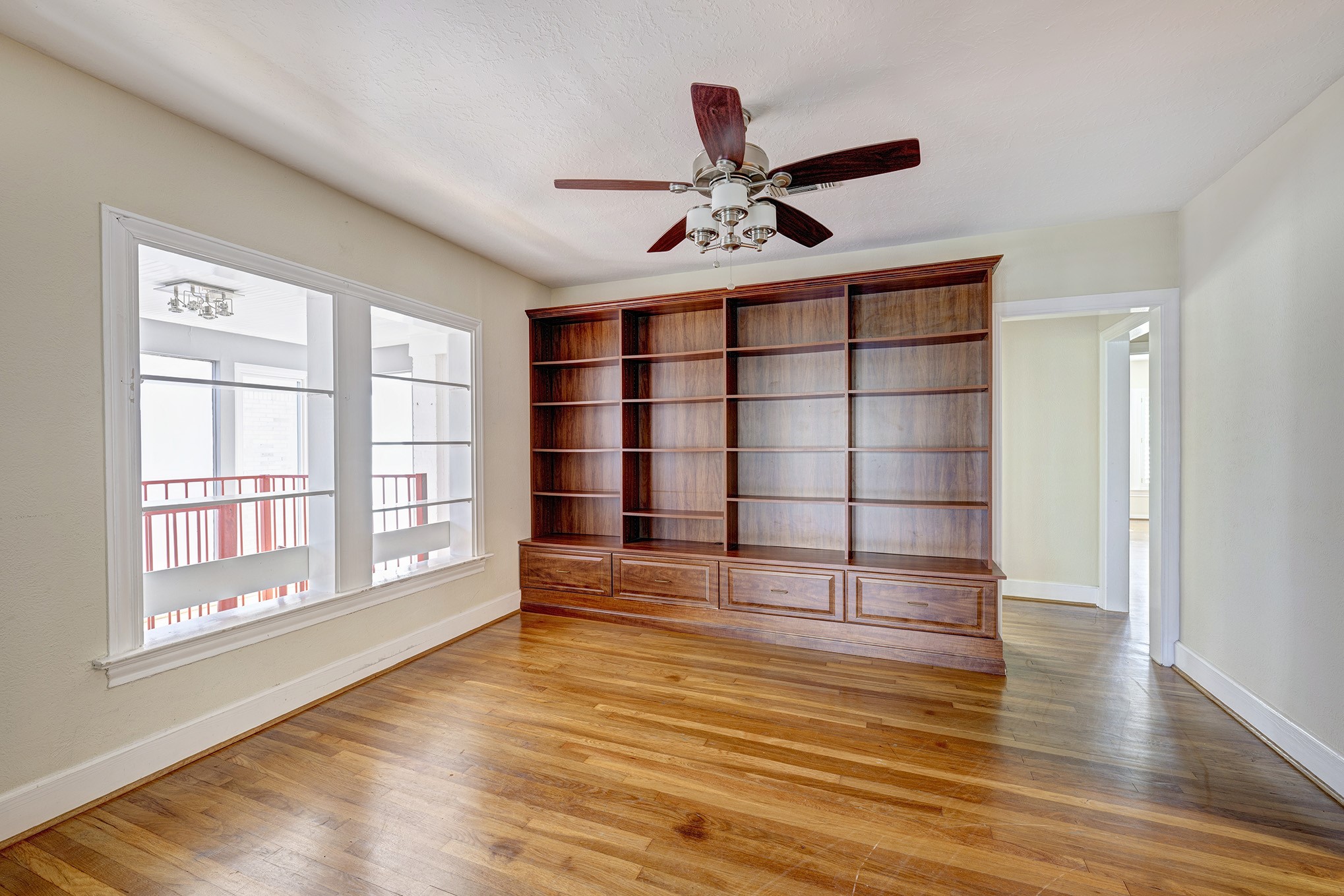 1919 West McKinney Street Houston, TX 77019 - Photo 17 of 31 a view of an empty room with a window and wooden floor