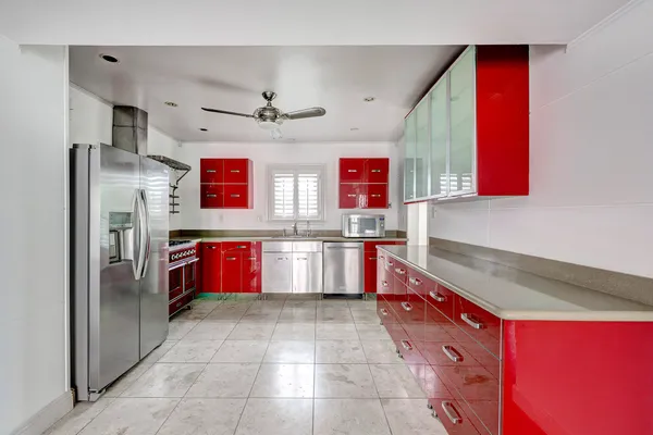 a kitchen with stainless steel appliances granite countertop a stove a sink and a refrigerator