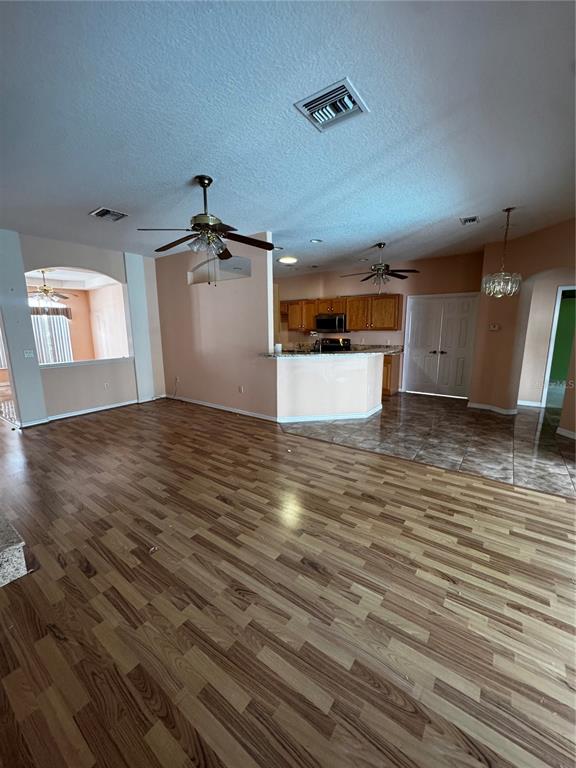 15296 Southwest 15th Terrace Road Ocala, FL 34473 - Photo 8 of 15 an empty room with wooden floor and windows