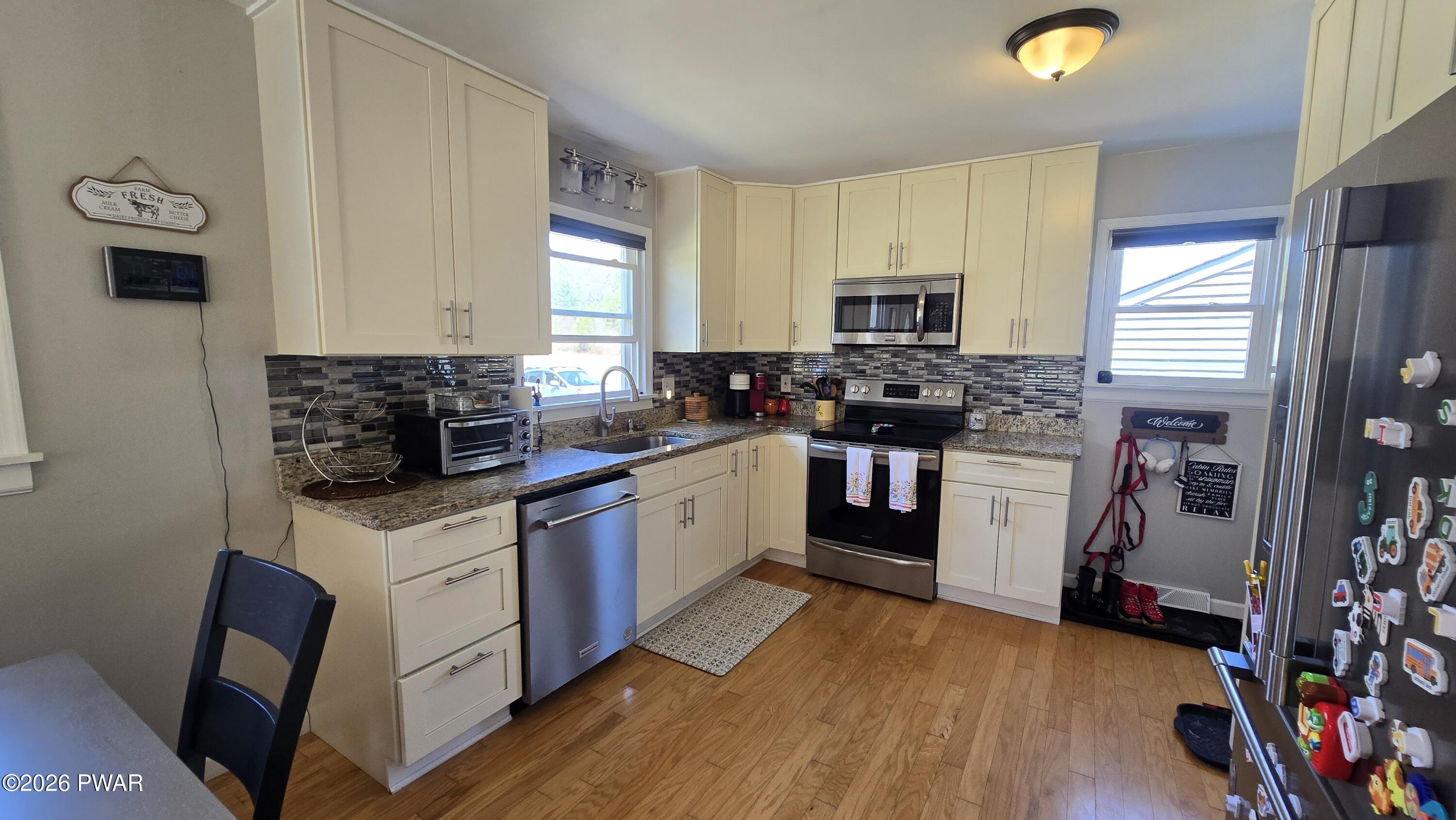 430 Griffith Road Tyler Hill, PA 18469 - Photo 7 of 31 a kitchen with stainless steel appliances granite countertop a stove sink and cabinets