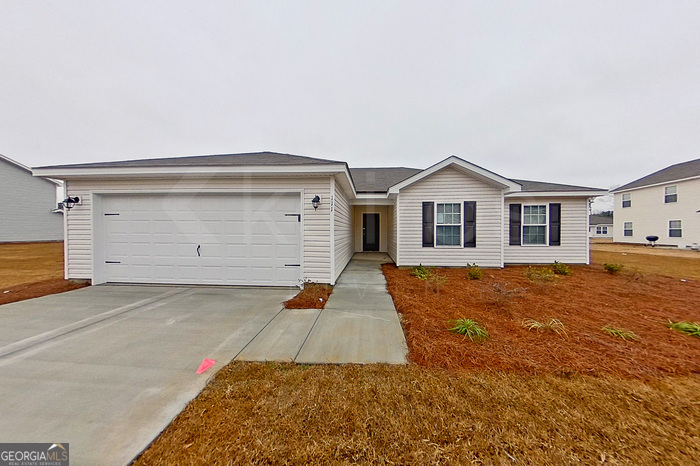 a view of a house with a yard and garage