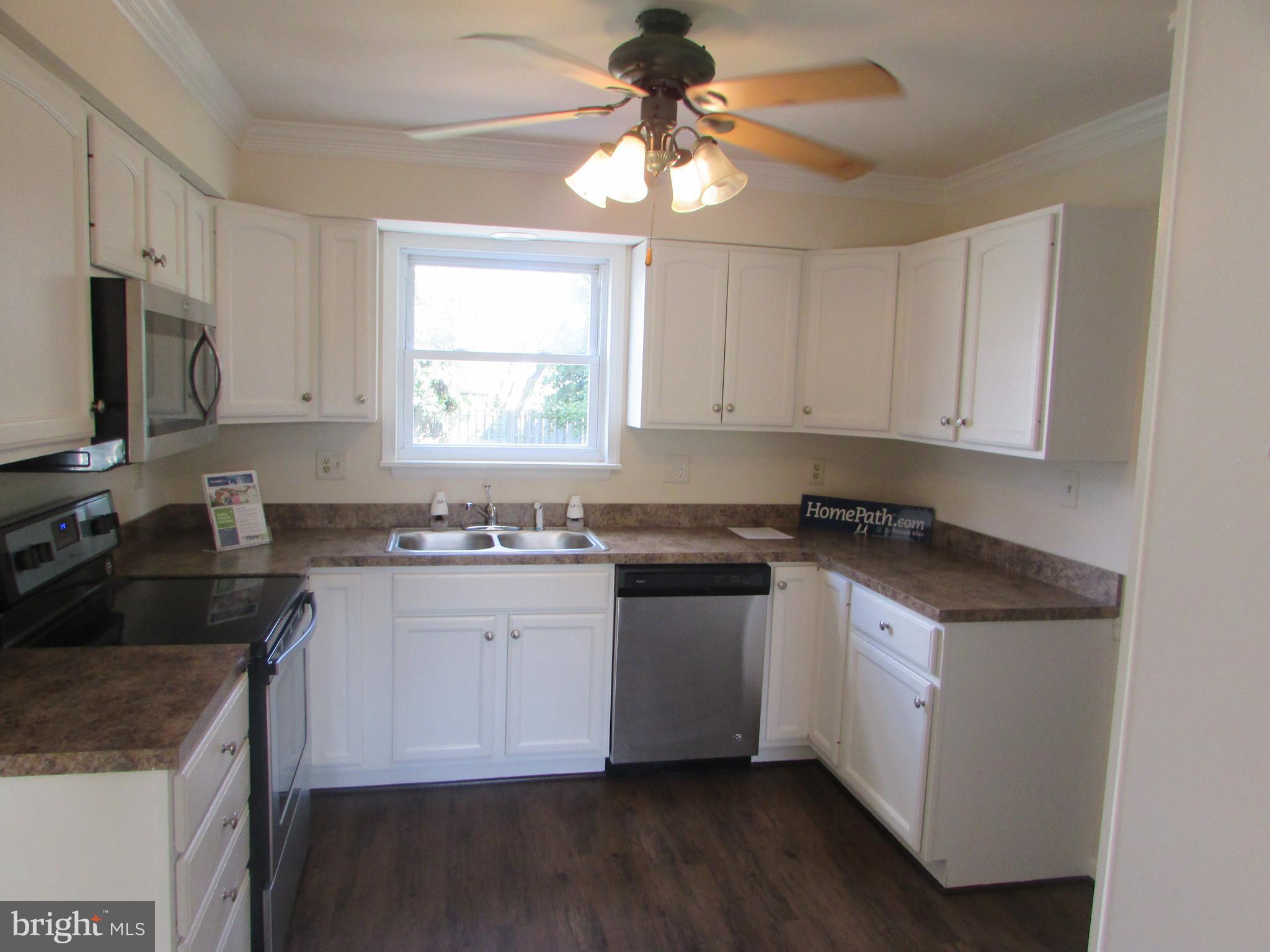 83 Trevanion Road Taneytown, MD 21787 - Photo 8 of 28 a kitchen with granite countertop a sink cabinets stainless steel appliances and a window