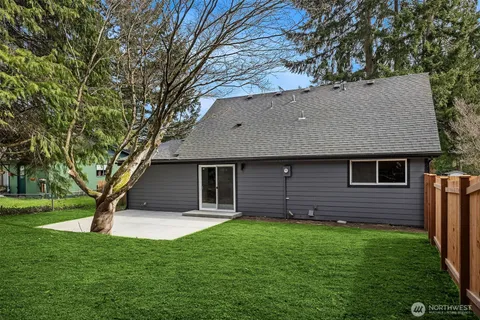 a view of backyard of house with green space