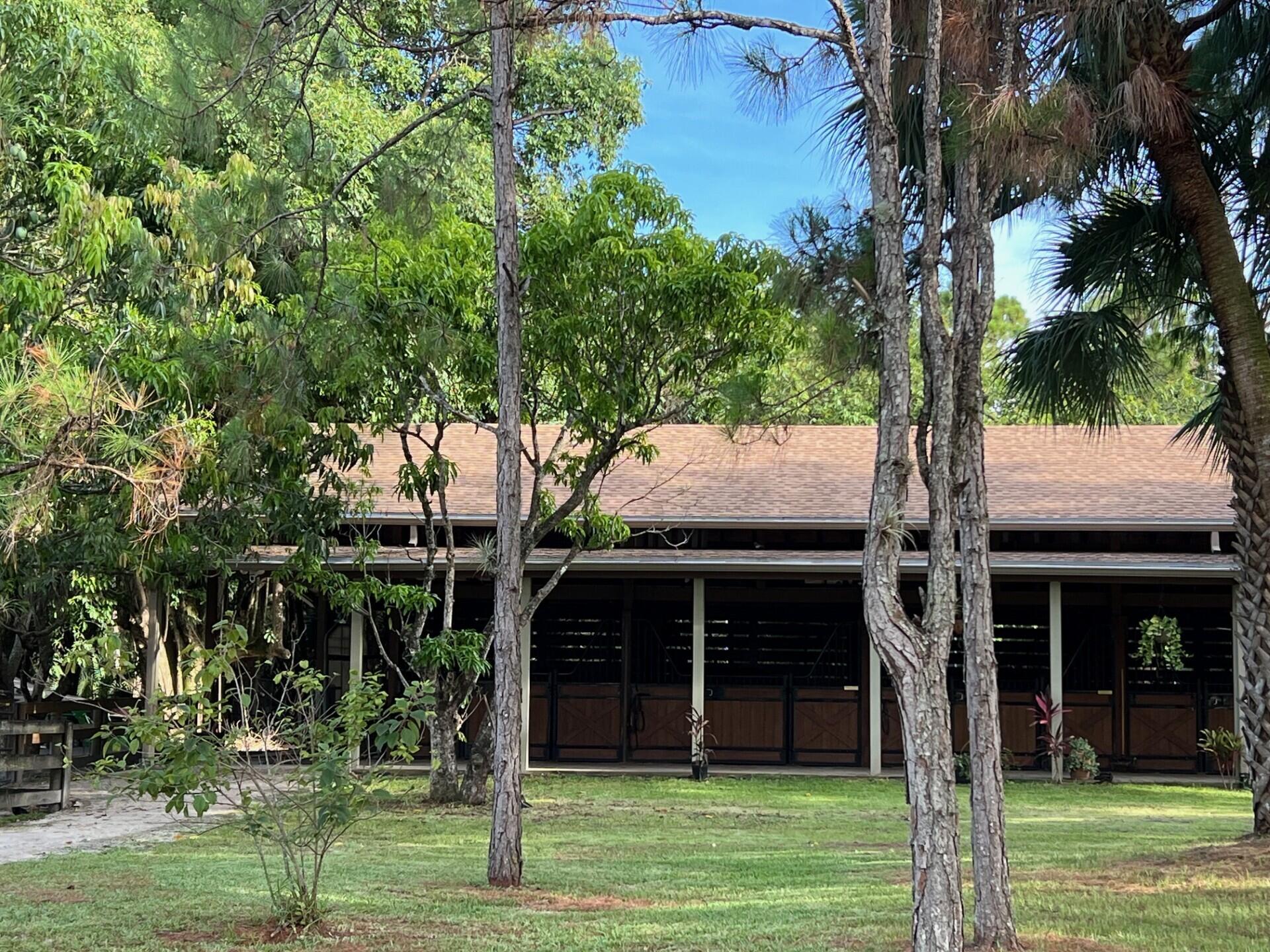 1711 Stallion Drive Loxahatchee, FL 33470 - Photo 12 of 23 a front view of house with a garden