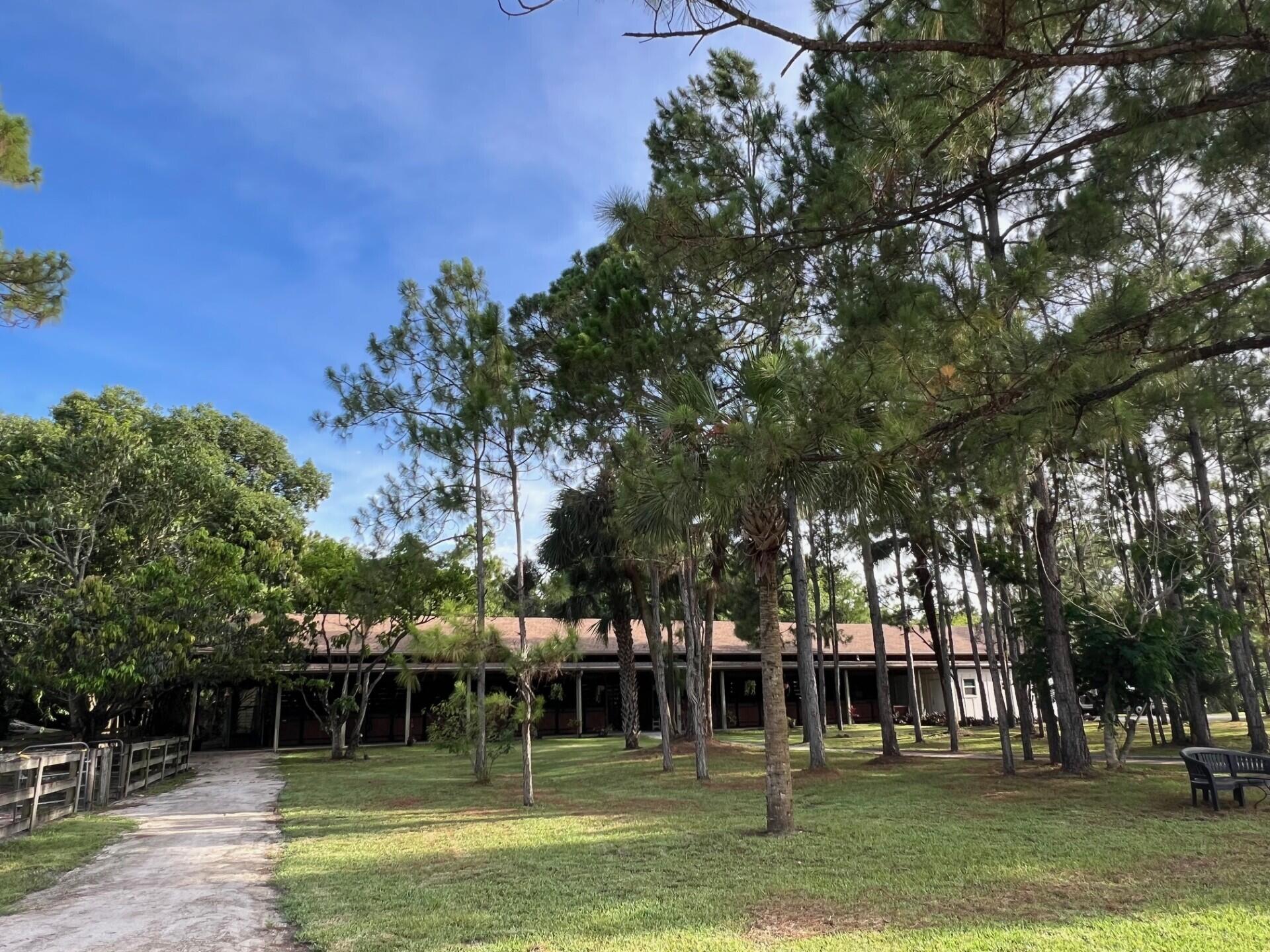 1711 Stallion Drive Loxahatchee, FL 33470 - Photo 13 of 23 a view of a swimming pool with a bench
