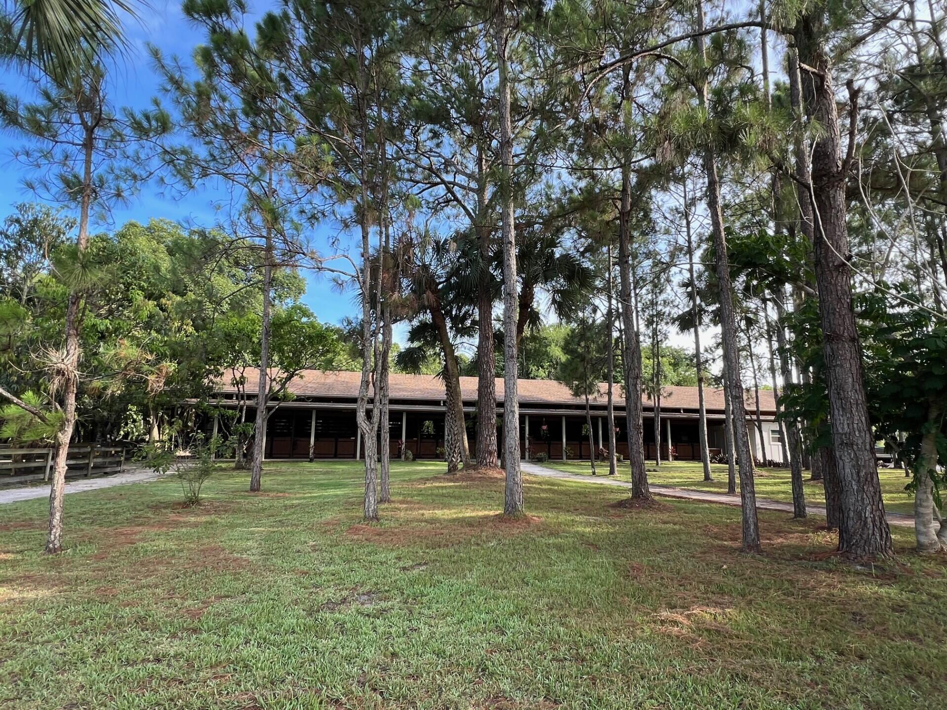 1711 Stallion Drive Loxahatchee, FL 33470 - Photo 14 of 23 a front view of a house with a garden