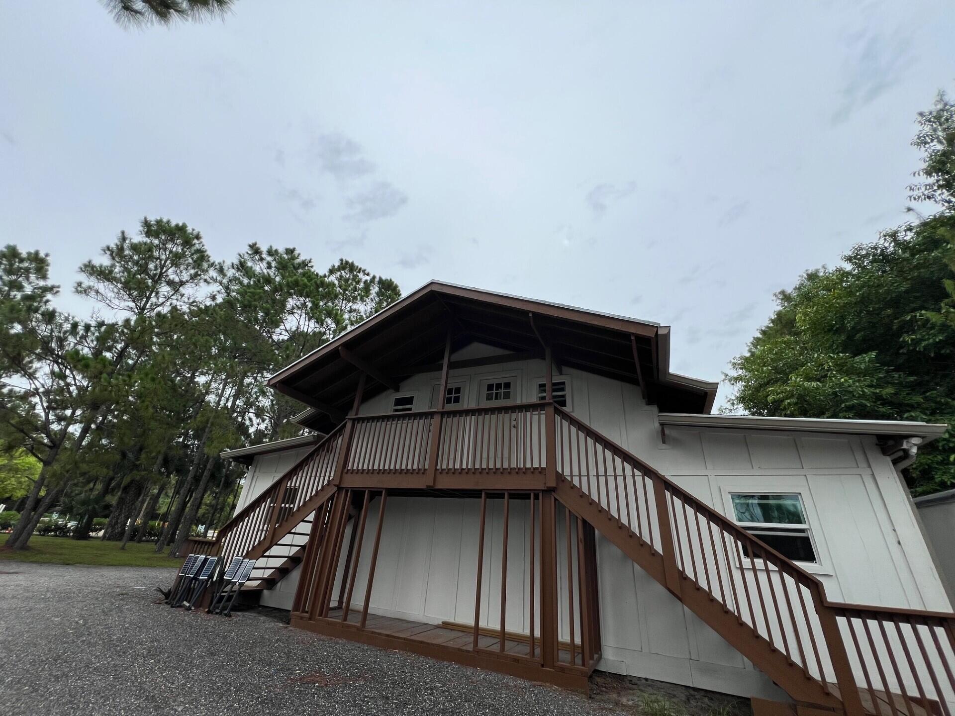 1711 Stallion Drive Loxahatchee, FL 33470 - Photo 16 of 23 a view of balcony with wooden floor and fence