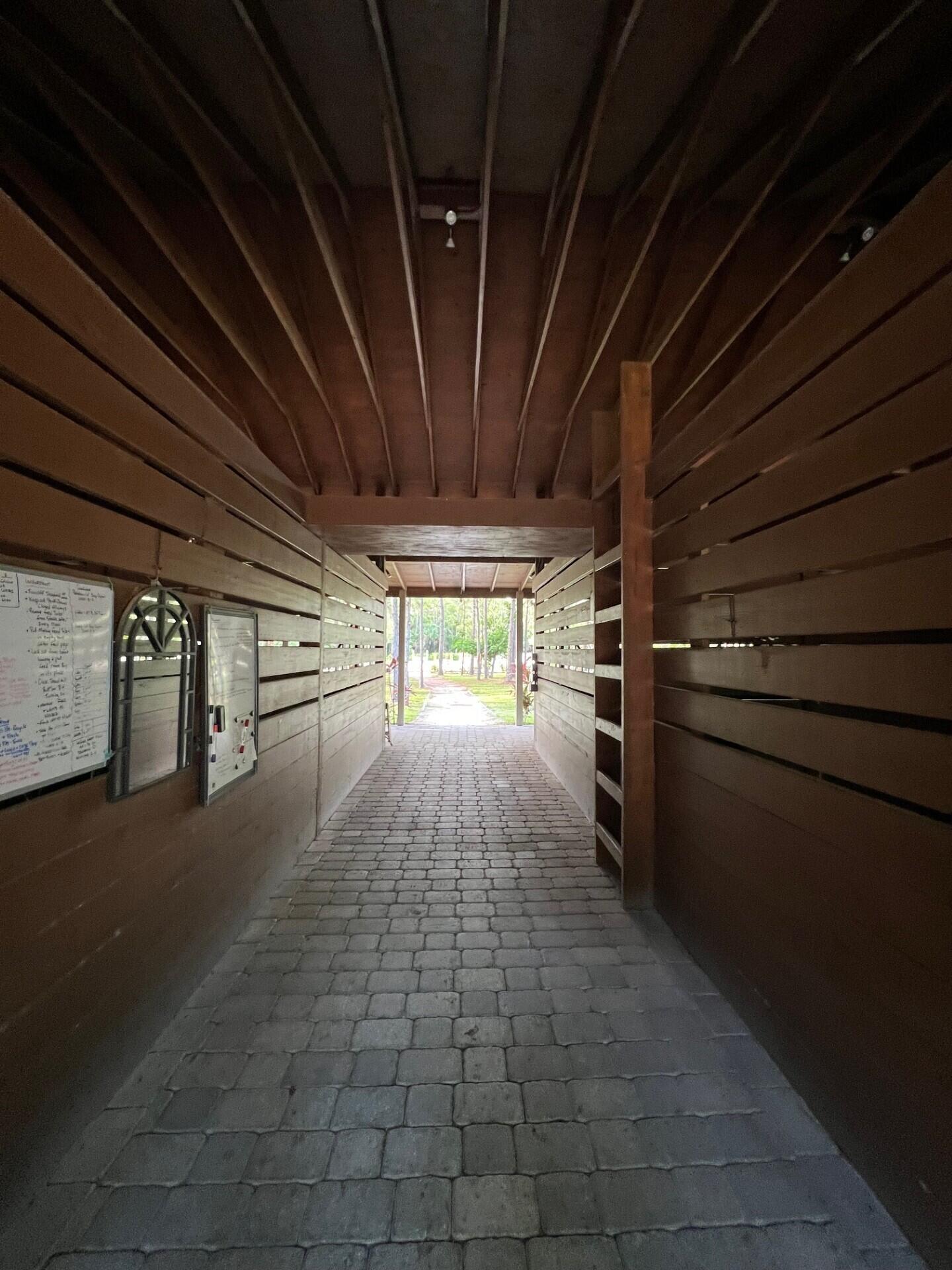 1711 Stallion Drive Loxahatchee, FL 33470 - Photo 17 of 23 a view of empty room with wooden floor