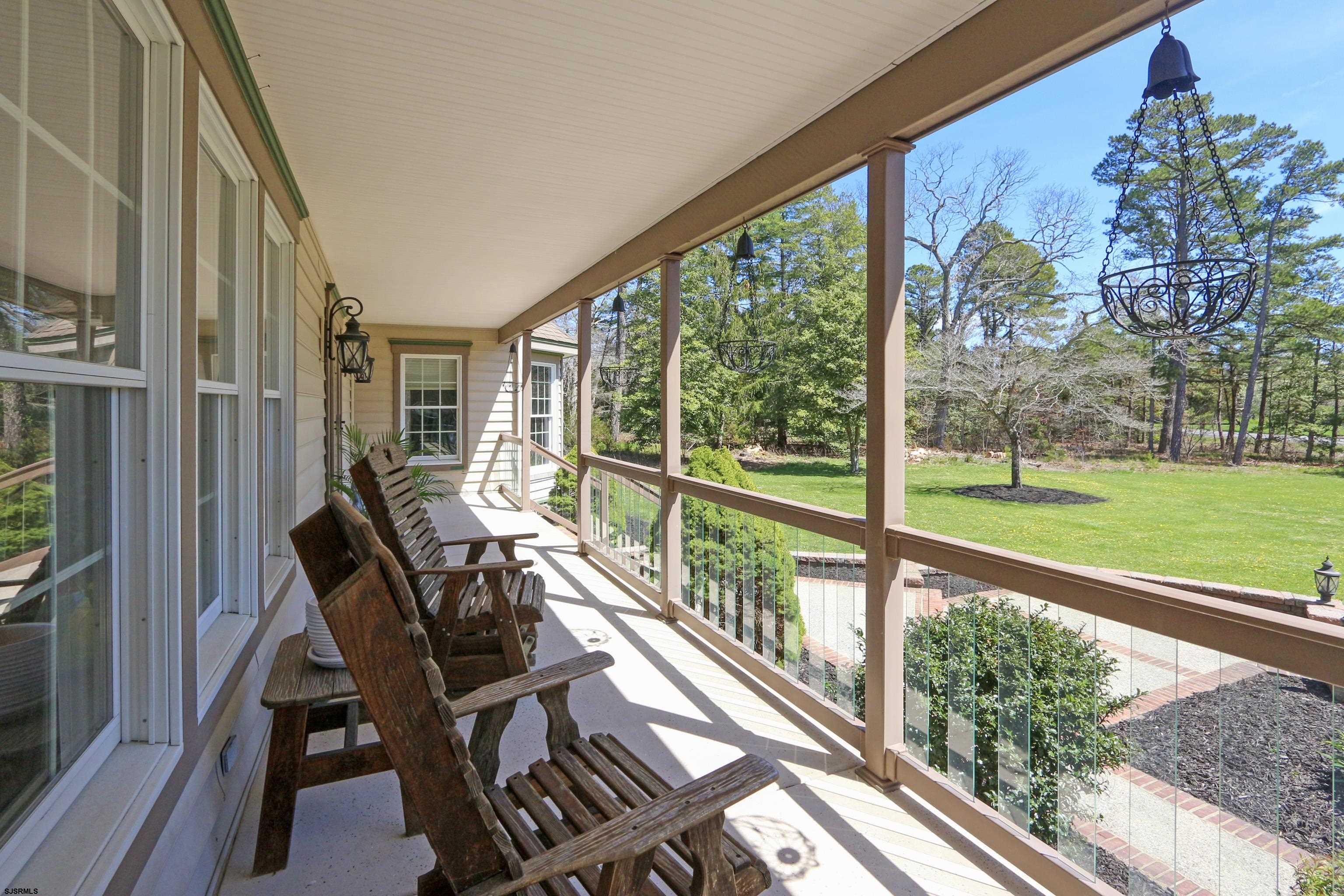 1322 Shore Road Palermo, NJ 08230 - Photo 2 of 56 a view of a balcony with chairs and wooden floor