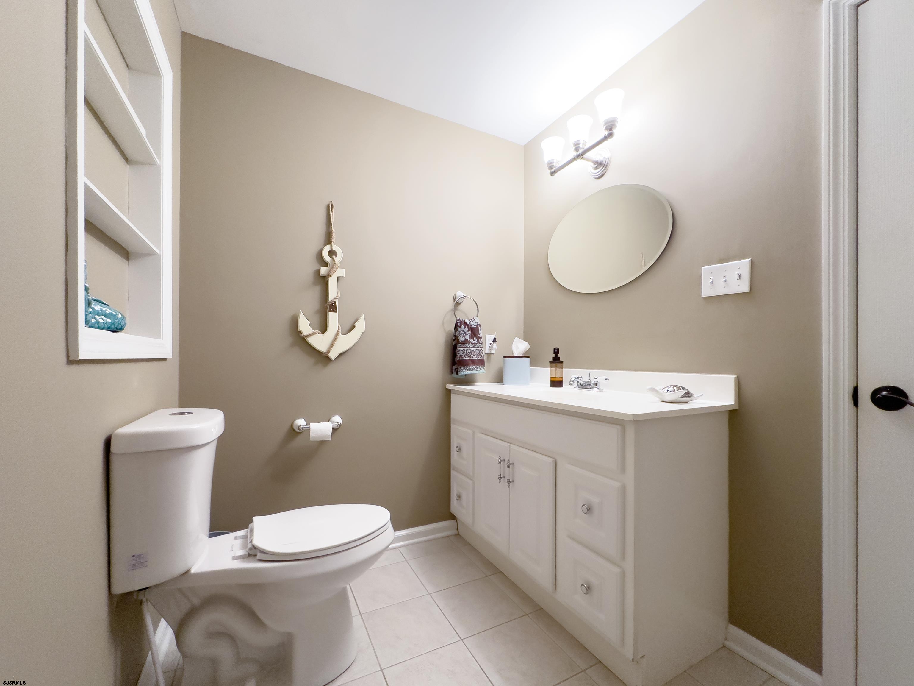 1322 Shore Road Palermo, NJ 08230 - Photo 21 of 56 a spacious bathroom with a toilet sink and mirror