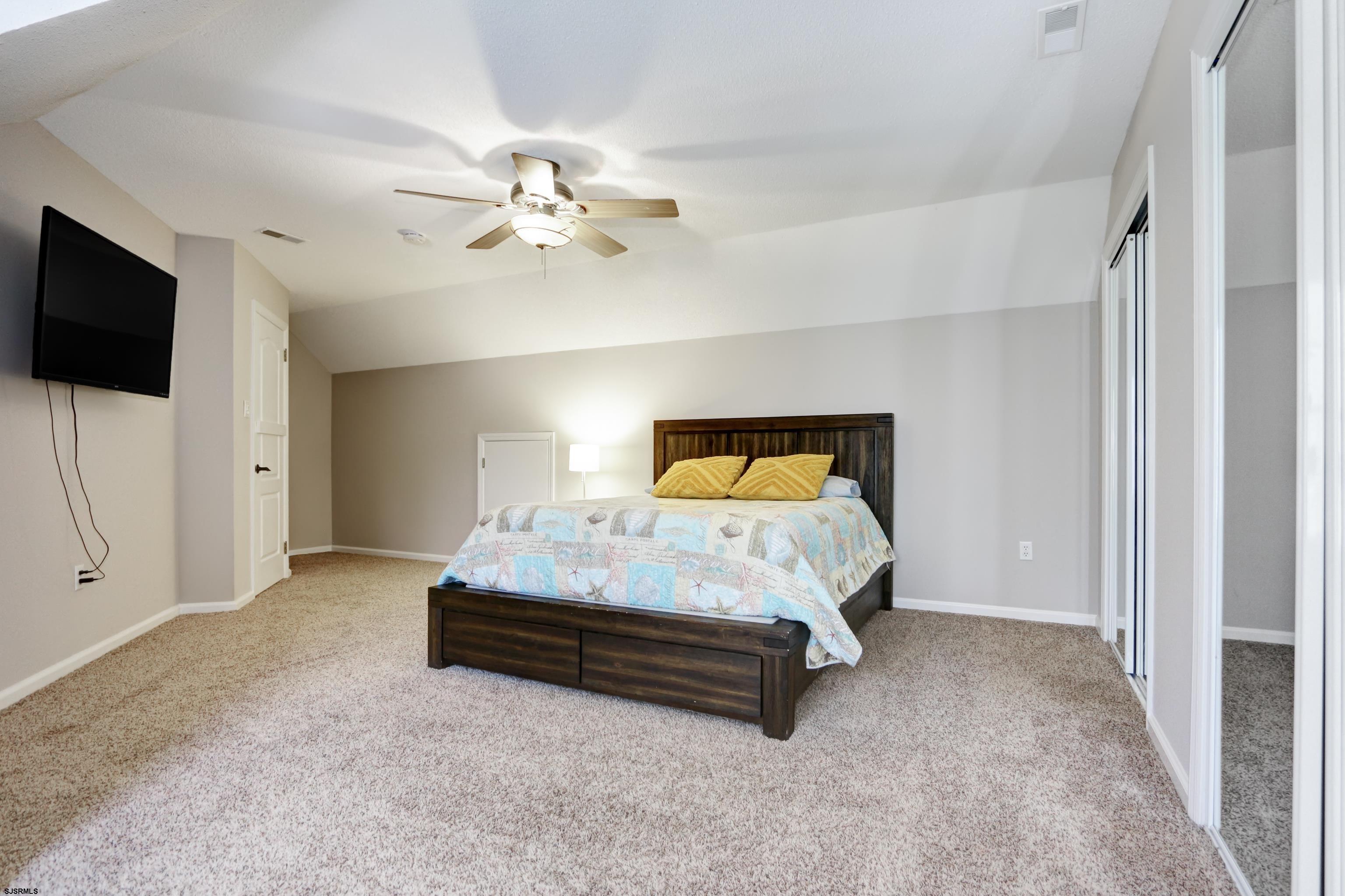 1322 Shore Road Palermo, NJ 08230 - Photo 30 of 56 a bedroom with a bed and a flat tv screen on the dresser