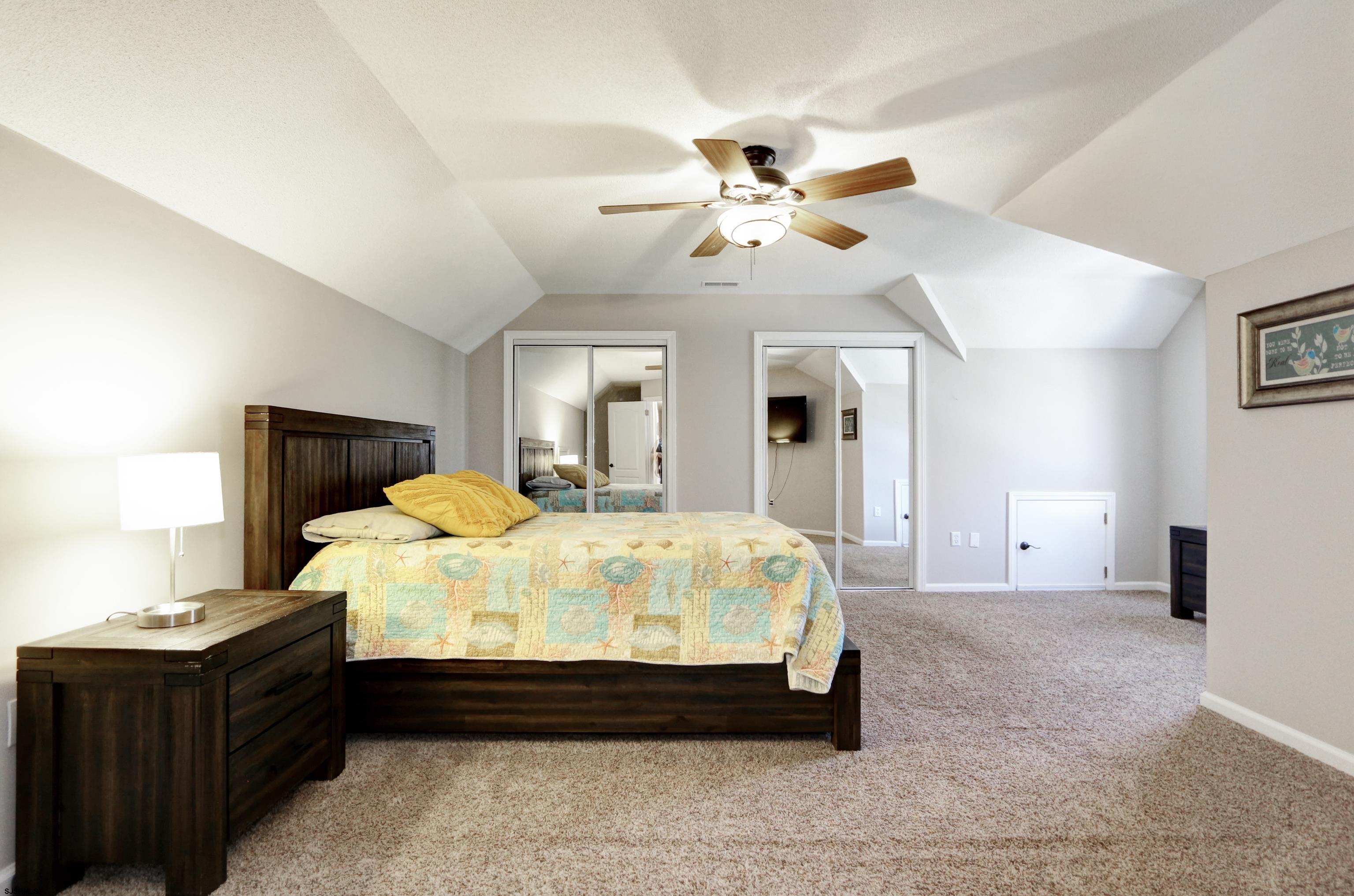 1322 Shore Road Palermo, NJ 08230 - Photo 31 of 56 a bed sitting in a bedroom next to a lamp