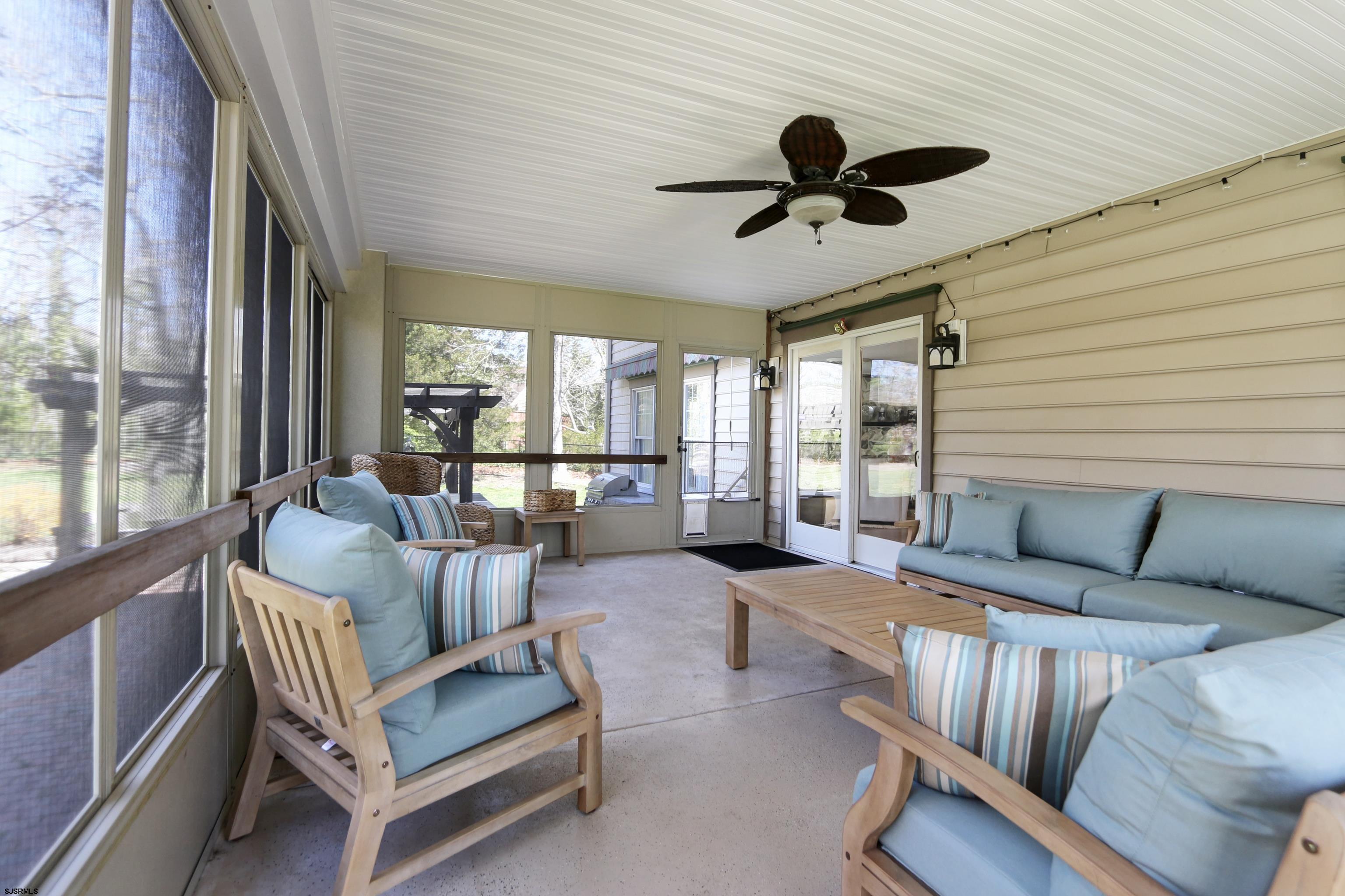 1322 Shore Road Palermo, NJ 08230 - Photo 38 of 56 a living room with furniture ceiling fan and a large window