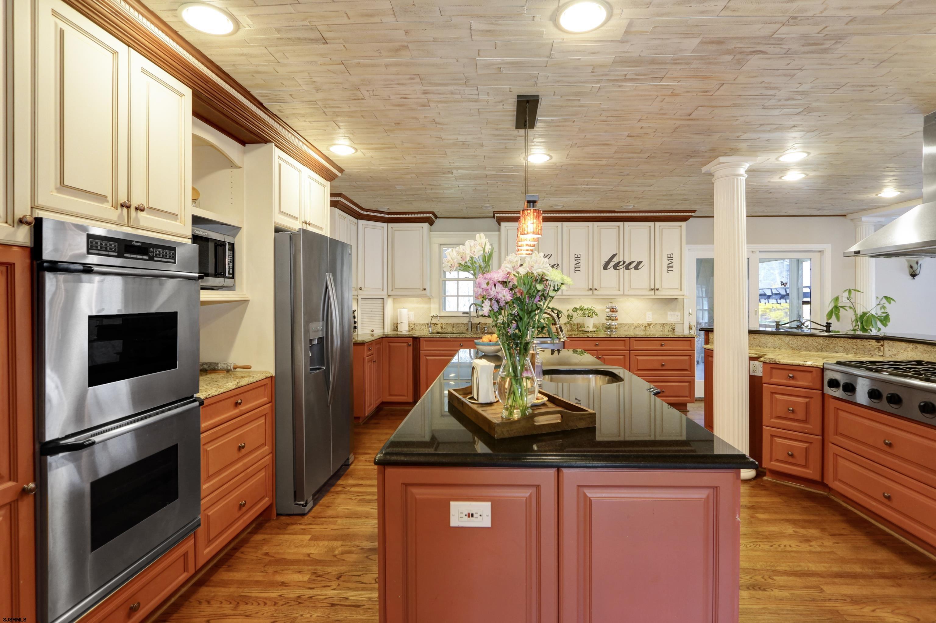 1322 Shore Road Palermo, NJ 08230 - Photo 7 of 56 a kitchen with stainless steel appliances kitchen island granite countertop a refrigerator a stove and a sink with wooden floor