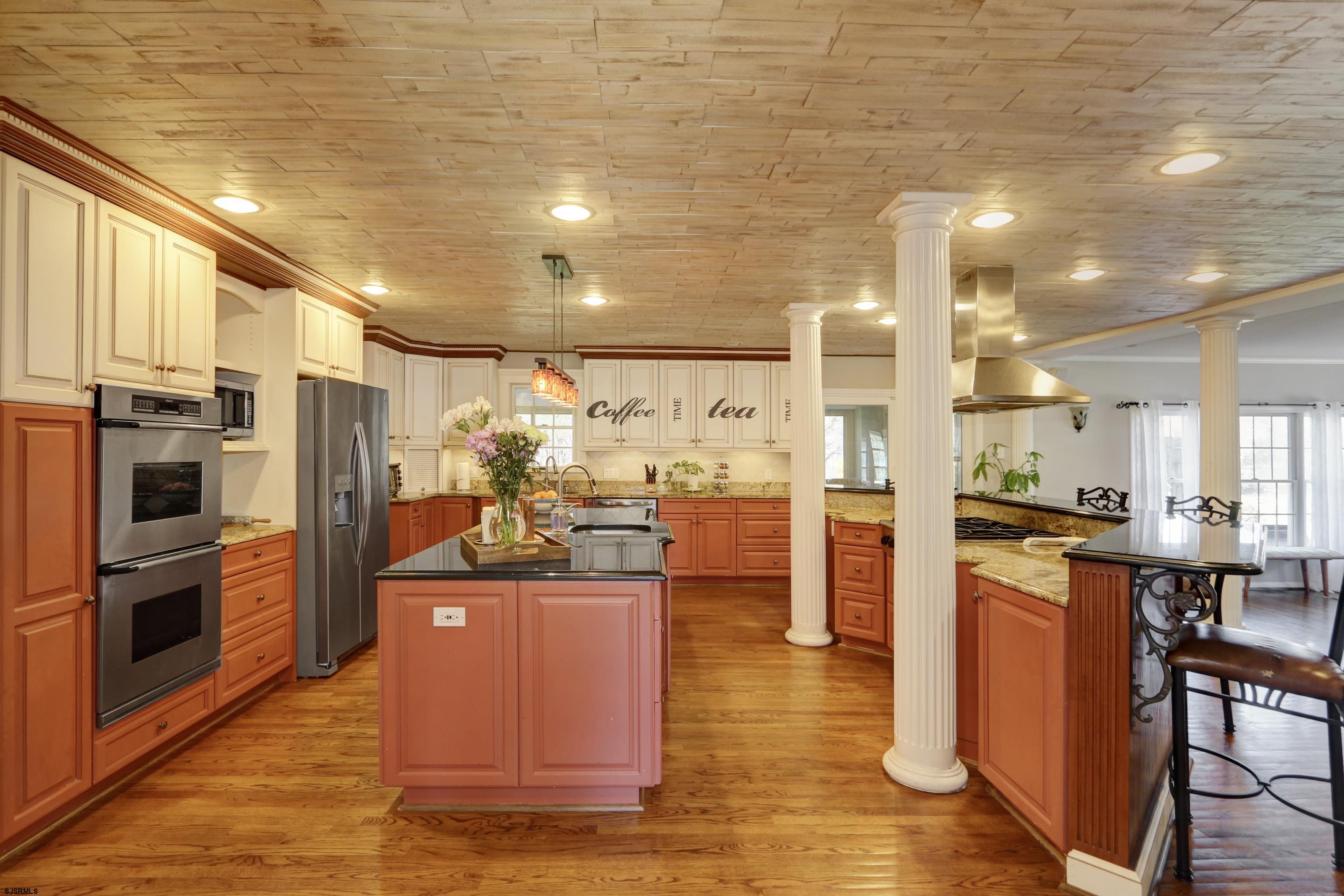 1322 Shore Road Palermo, NJ 08230 - Photo 8 of 56 a kitchen with stainless steel appliances kitchen island granite countertop a refrigerator a stove and a sink with cabinets