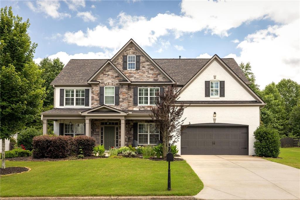a front view of a house with a yard and garage