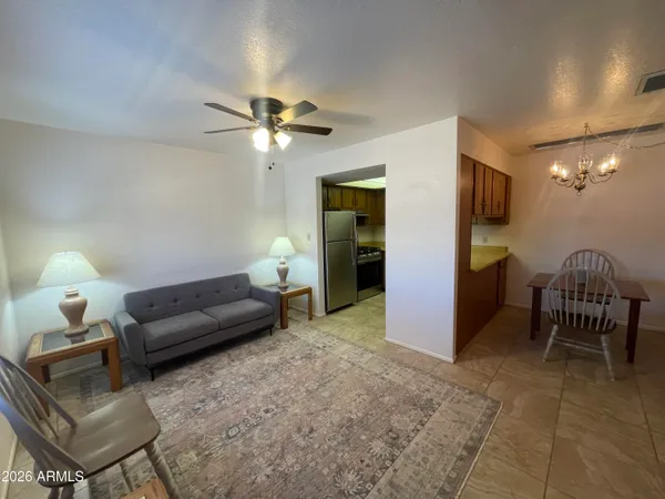 a living room with furniture and a lamp