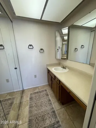 a bathroom with a sink a toilet and mirror