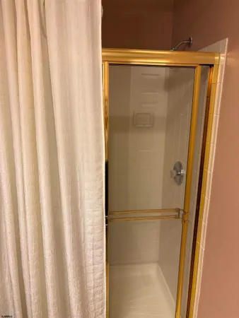 a bathroom with a glass shower door