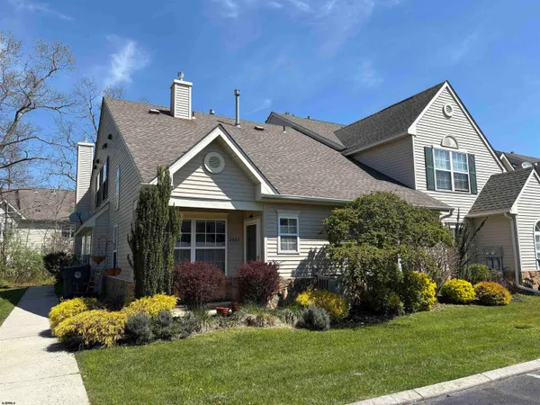 a view of a house with a yard and plants