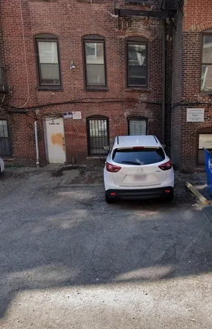 a car parked in front of a brick house