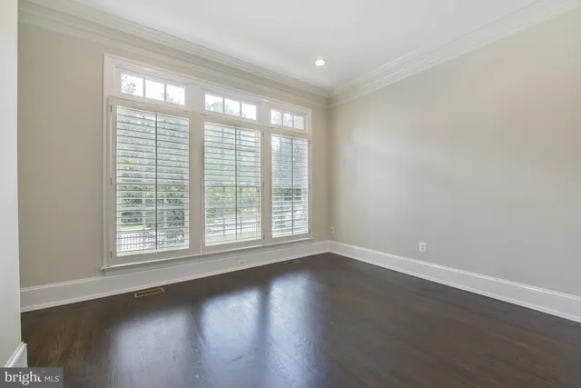 a view of wooden floor and windows in a room
