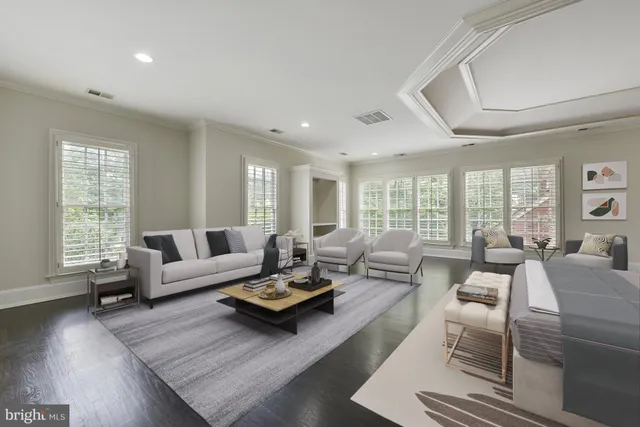 a living room with furniture wooden floor and a large window