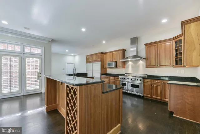 a kitchen with stainless steel appliances granite countertop a stove and a refrigerator