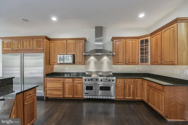 a kitchen with stainless steel appliances granite countertop a stove and a sink